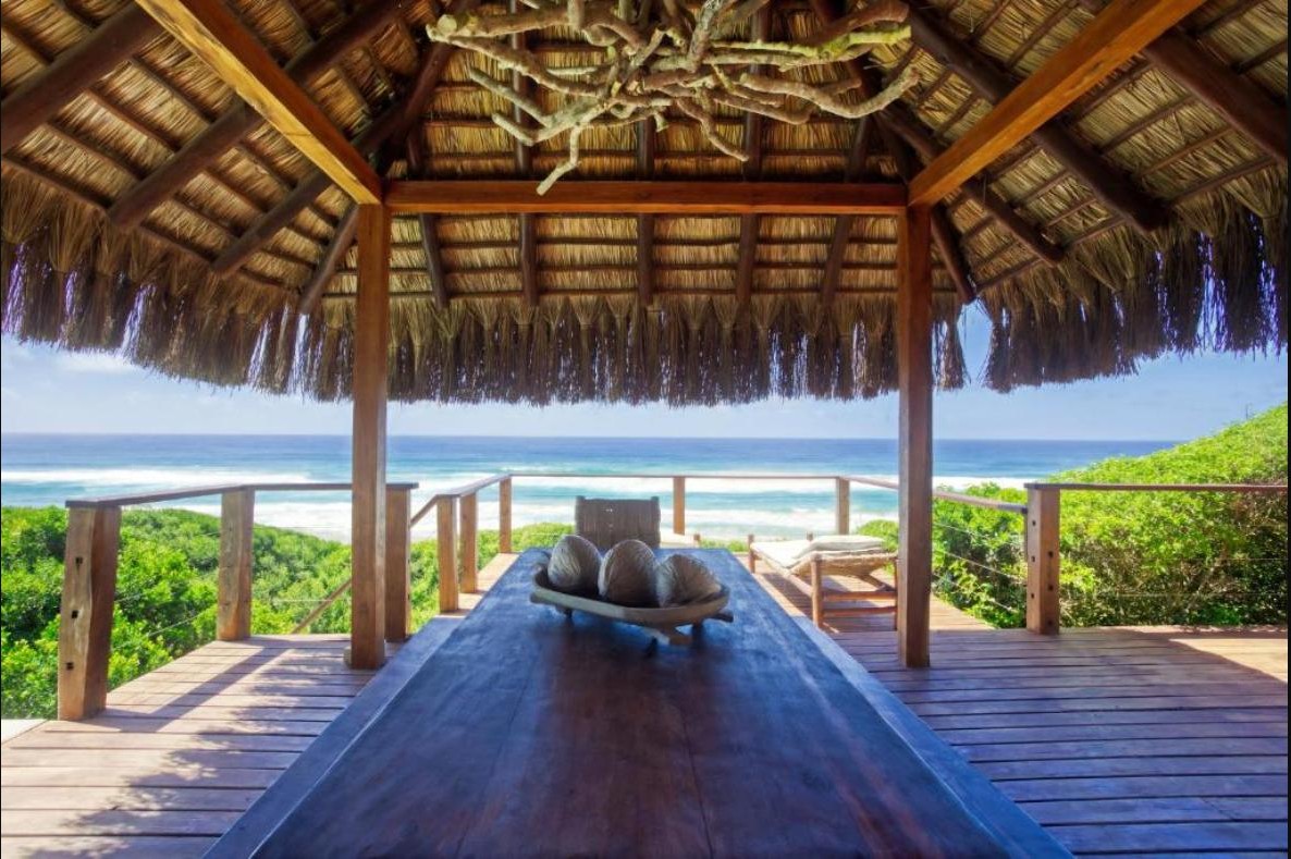 Reetgedecktes Lapa-Essdeck mit Blick aufs Meer am Strandhaus Aloha 6, Ponta Mamoli, Mosambik